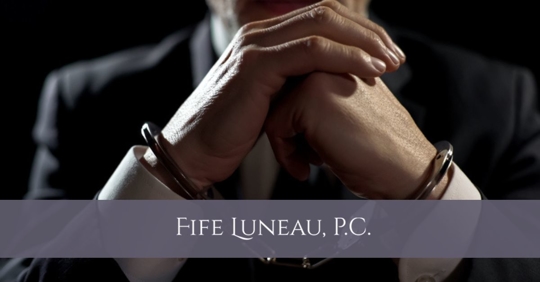 man with handcuffs in a suit