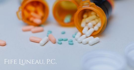 open pill bottles on top of a white counter top in the kitchen